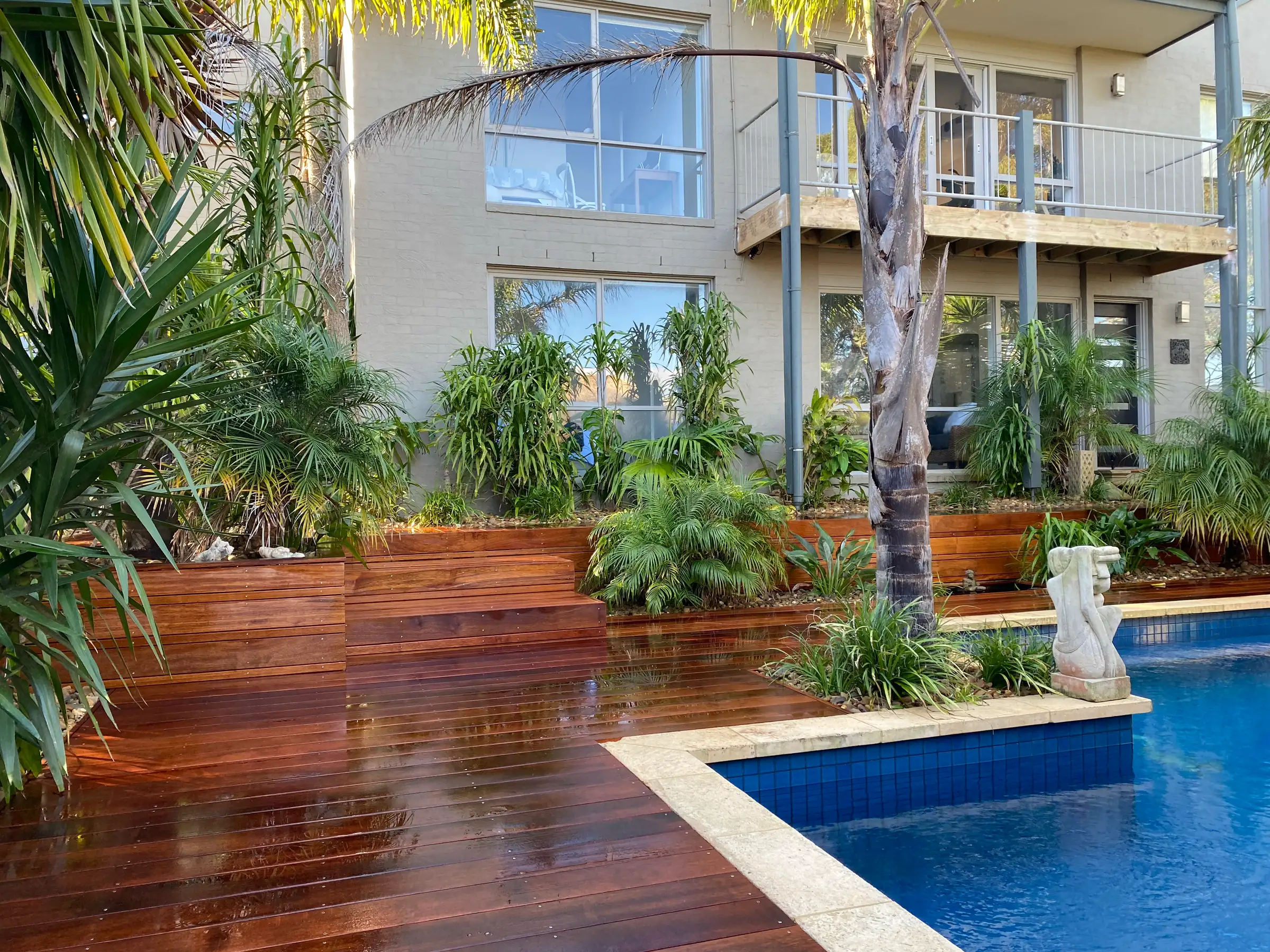 Timber deck with planter boxes beside a pool