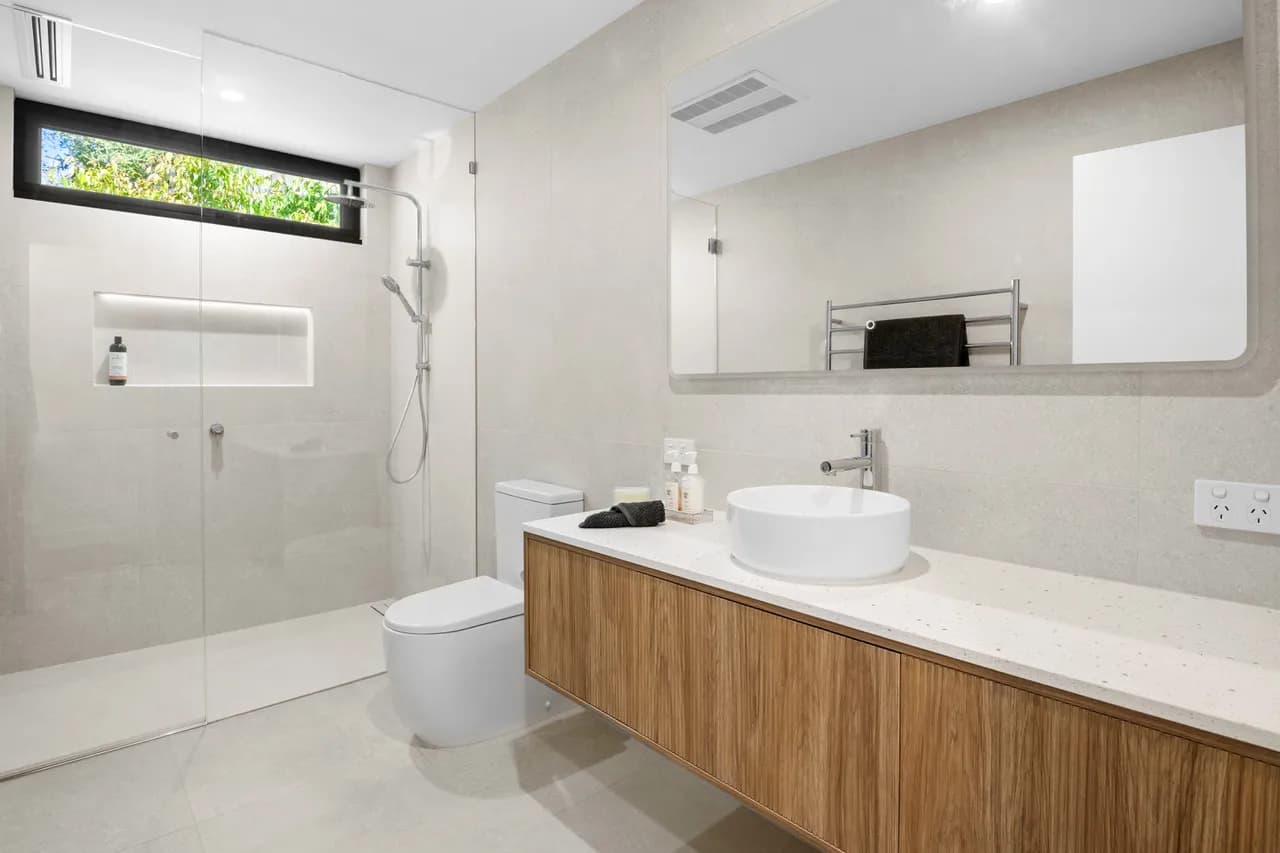 Renovated bathroom with a timber vanity and vessel basin