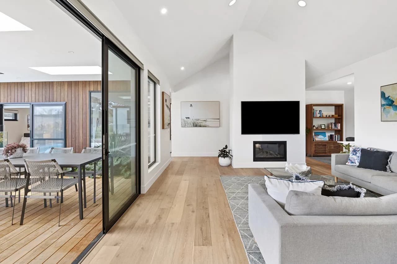 Living room with stacker doors opening onto a timber deck