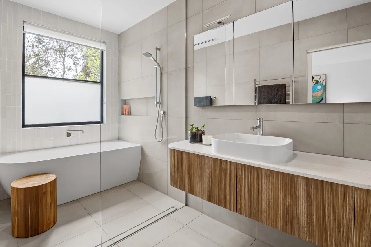 Renovated bathroom with a freestanding bath and timber vanity