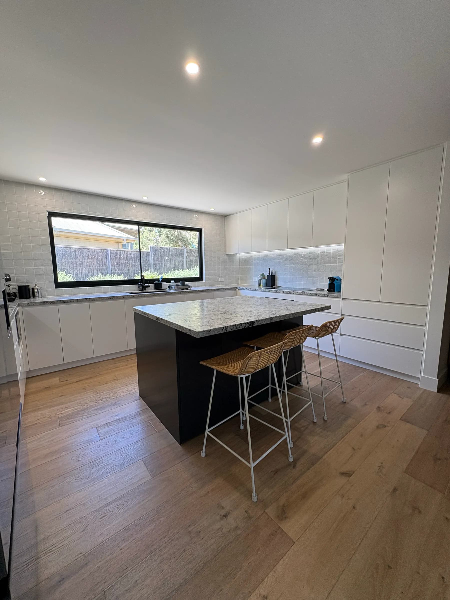 Renovated kitchen with an island bench and window